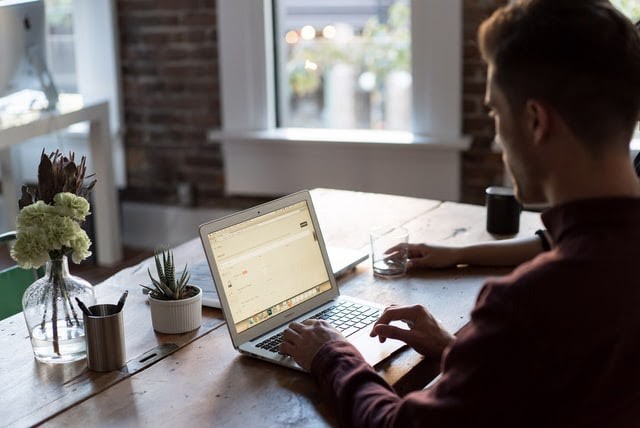 A man using a laptop on the table
