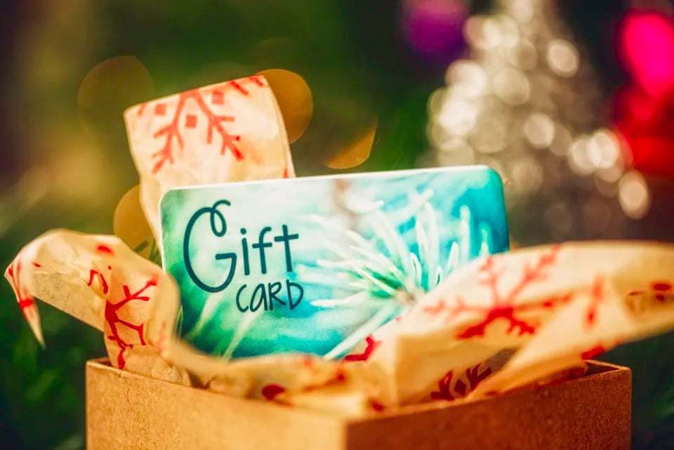 Christmas gift card in opened box in Christmas setting