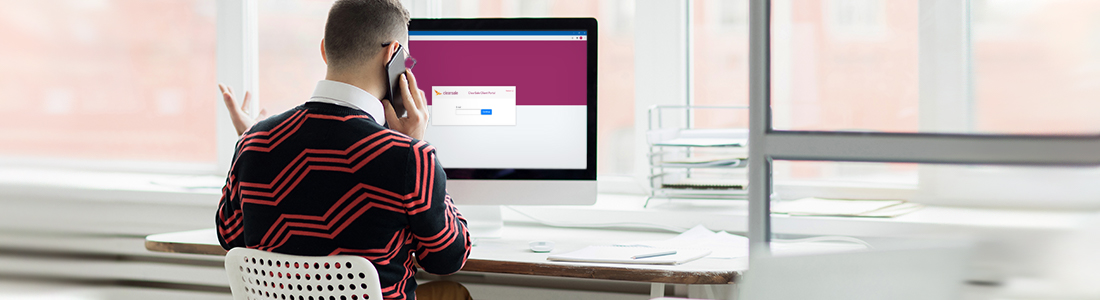 a man with the client on phone while looking at the ClearSale Client Portal on mac
