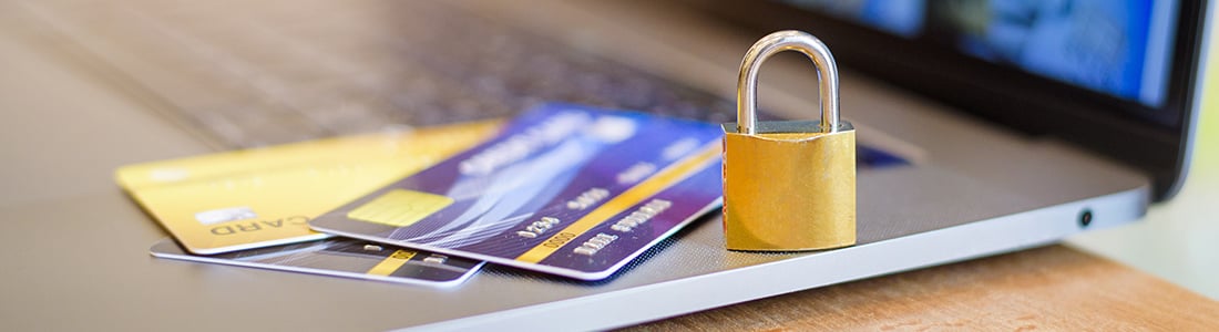  credit cards and a padlock on a notebook