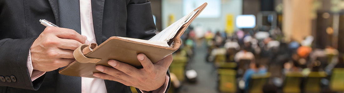 man taking notes on a notebook