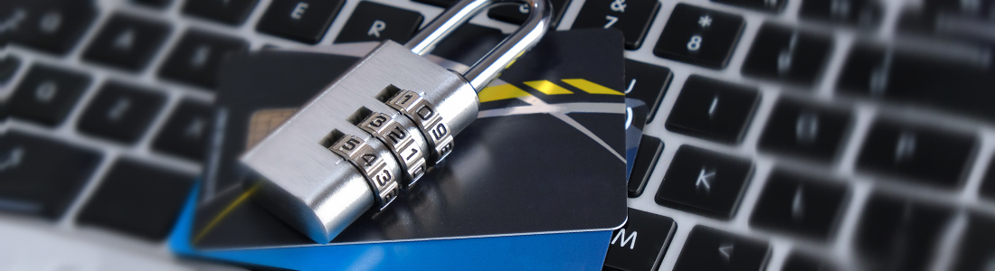 a padlock on top of credit cards that are on a keyboard